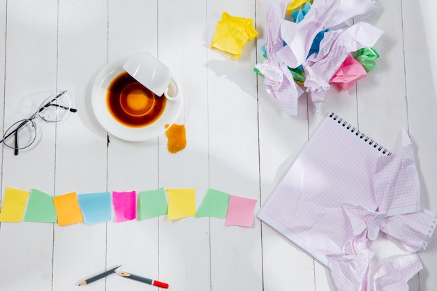 A chaotic collection of sticky notes and scribbled ideas scattered across a desk.