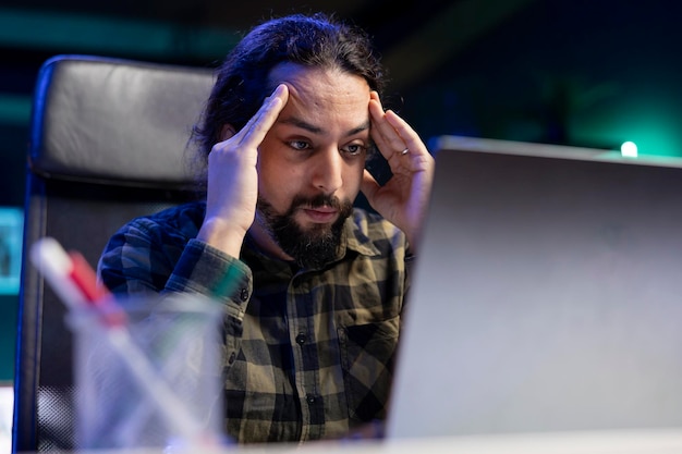 A developer looking confused at a complex no-code interface