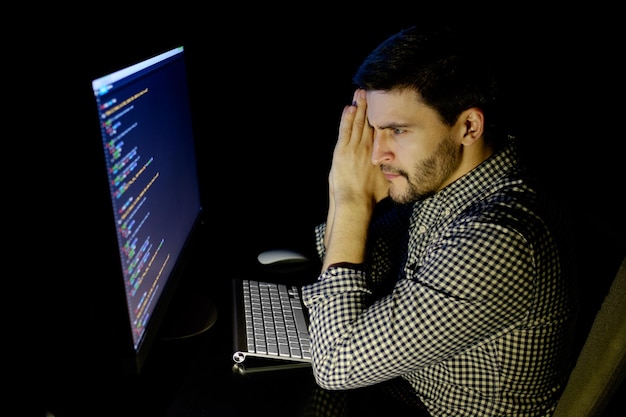 A developer looking dejected at a computer screen showing no user activity