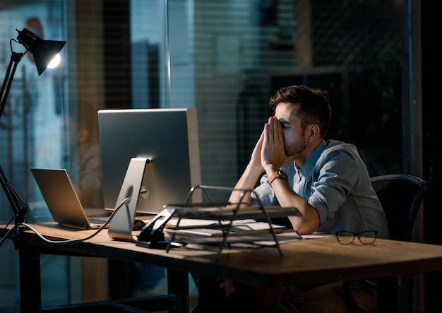 A developer staring intently at lines of code on a screen, looking stressed.
