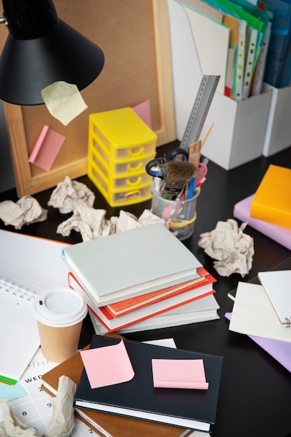 A messy desk with a laptop, coffee cup, and scattered notes, representing the chaos of solo founding.