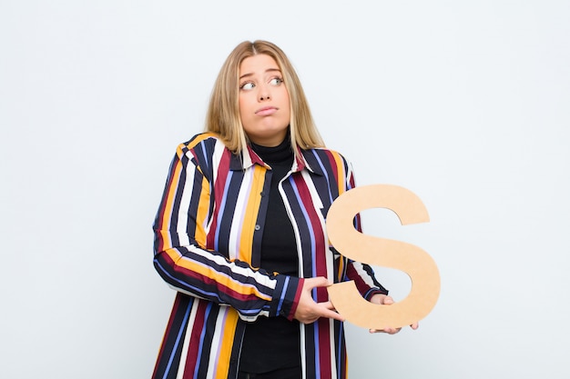 A person looking confused at a pricing table with question marks.