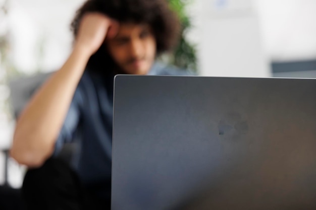 A person looking dejected at a computer screen with no notifications