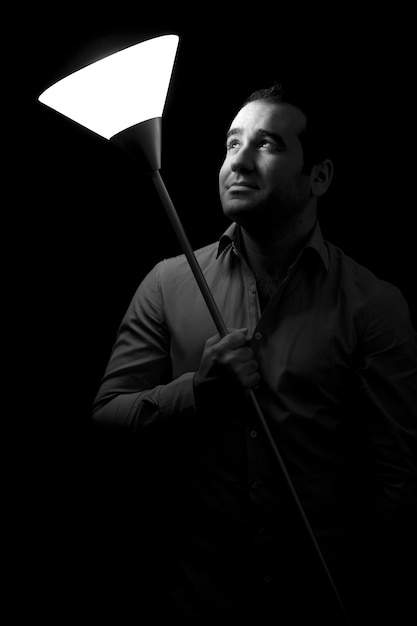 A person looking hesitant to share their work, with a spotlight on them.