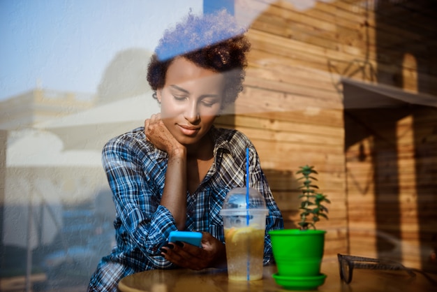 A person looking thoughtfully at a laptop screen with social media icons scattered around.