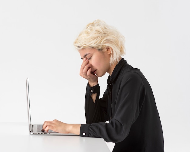 A person looking tired at a computer screen late at night