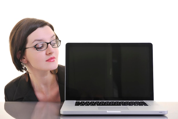 A person staring blankly at a laptop screen with a cursor blinking on a white document.